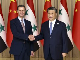 Chinese President Xi Jinping shakes hands with Syria's President Bashar al-Assad in eastern Hangzhou city